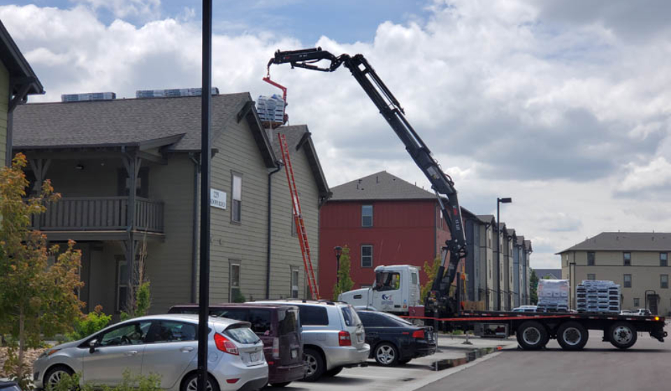 Exterior upgrades for rental properties showing a roof being replaced on a multi-family buidling